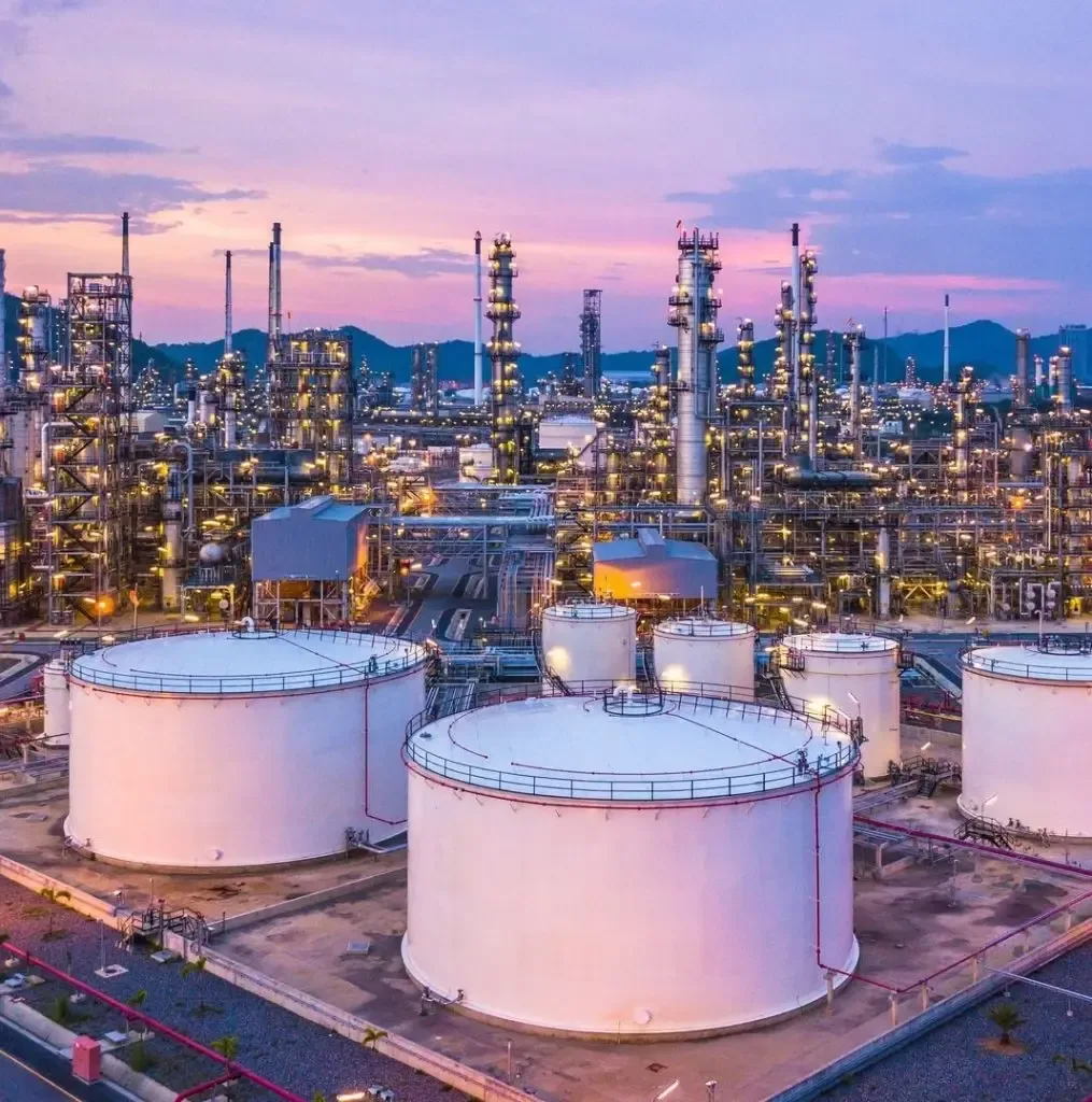 A refinery and its storage tanks at dusk