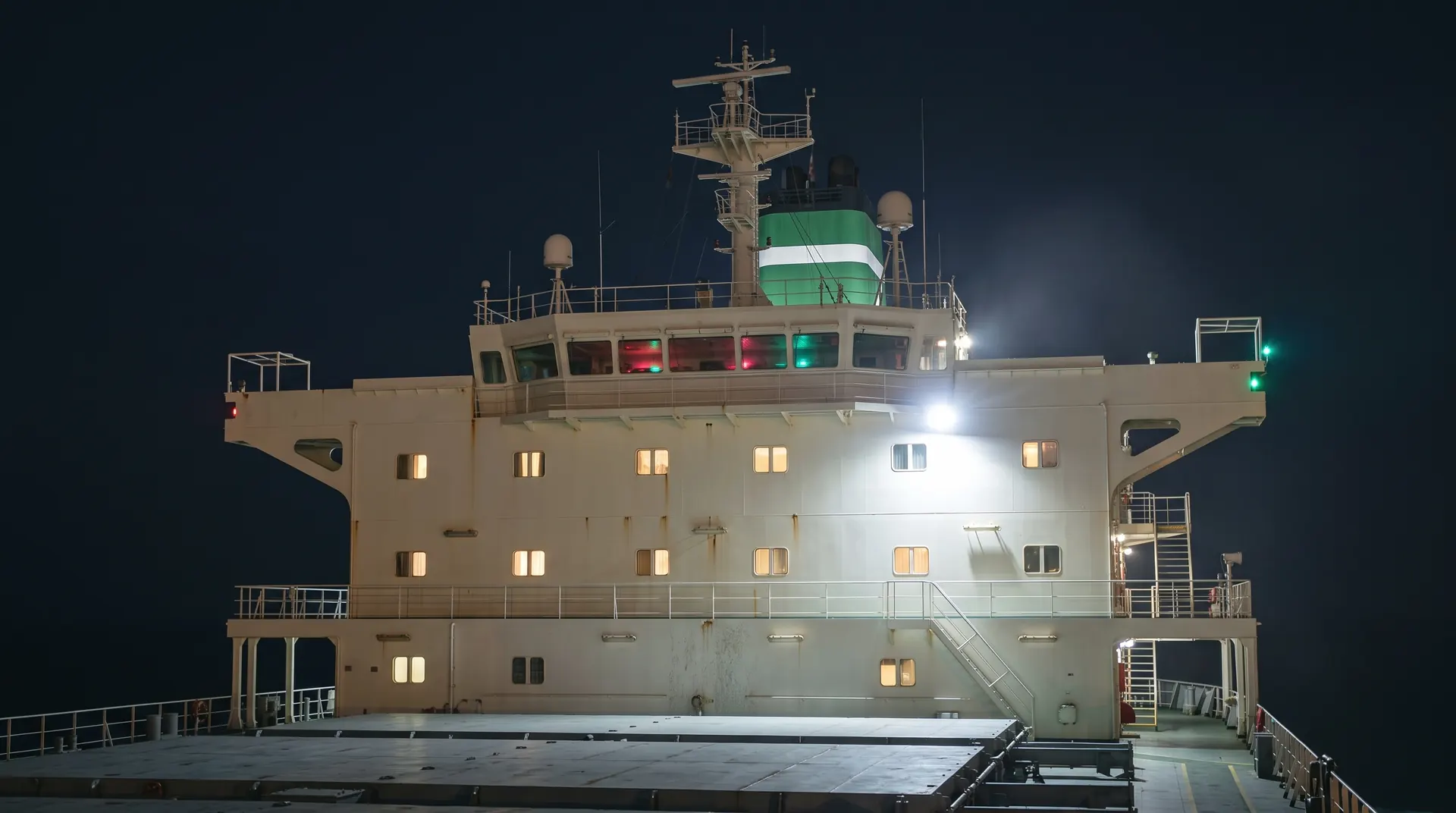 The bridge of the LARFI tanker at night, its windows lit