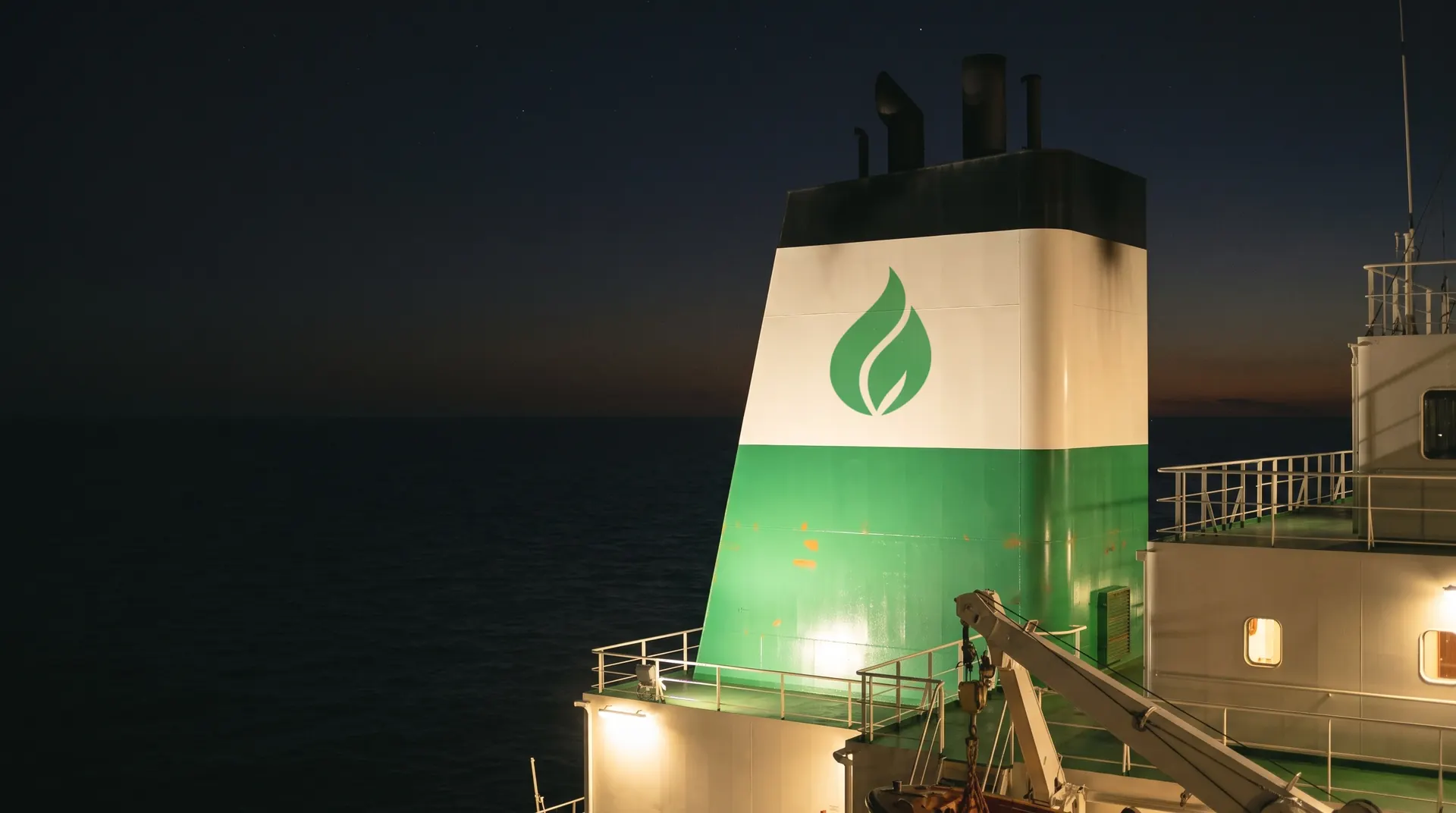 The funnel of the LARFI tanker at night, the green mark on its white band